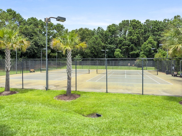 view of sport court featuring a yard