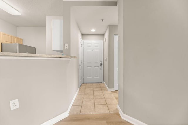 hallway with light hardwood / wood-style floors