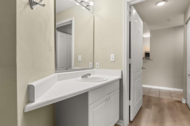 bathroom featuring vanity, hardwood / wood-style floors, and a textured ceiling