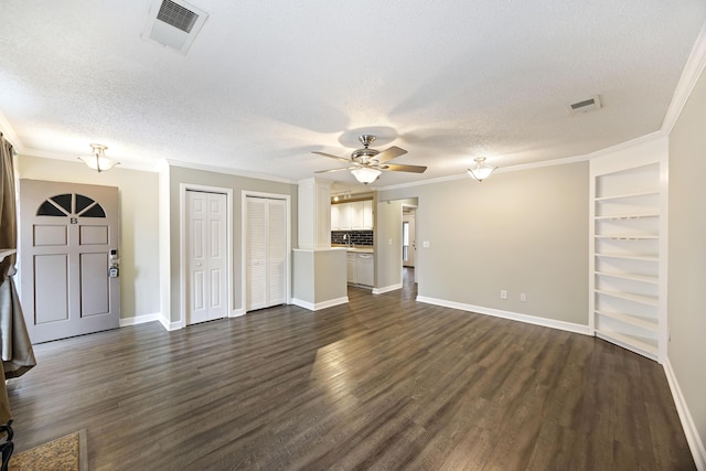 unfurnished living room with dark hardwood / wood-style floors, ornamental molding, and a textured ceiling