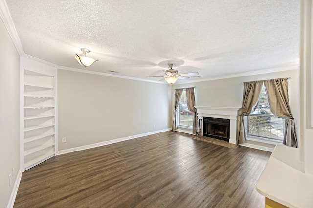 unfurnished living room featuring dark hardwood / wood-style flooring, a healthy amount of sunlight, a textured ceiling, and ornamental molding