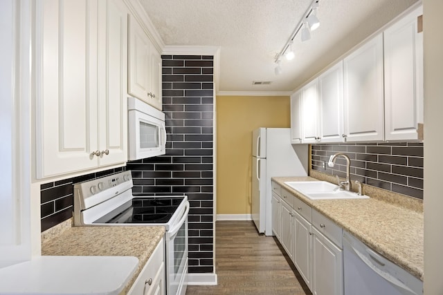 kitchen featuring white cabinetry, sink, dark wood-type flooring, and white appliances