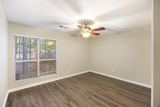 spare room featuring a textured ceiling, ceiling fan, and dark wood-type flooring