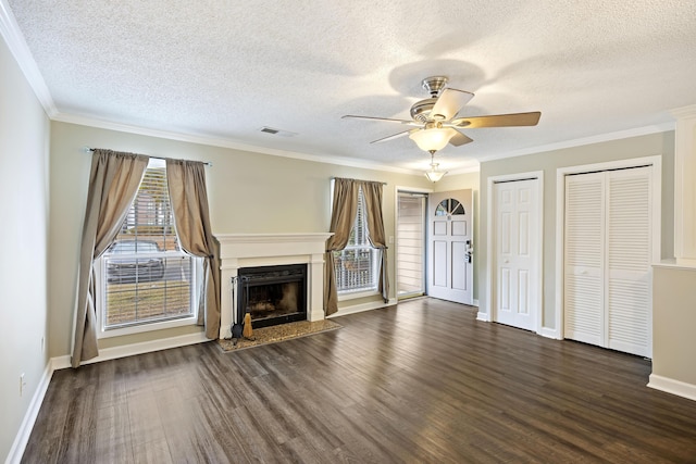 unfurnished living room with ceiling fan, dark wood-type flooring, a textured ceiling, and ornamental molding