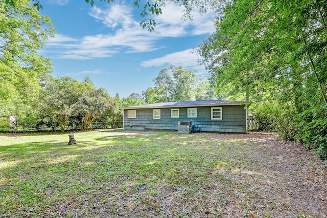 exterior space featuring central AC and a front yard