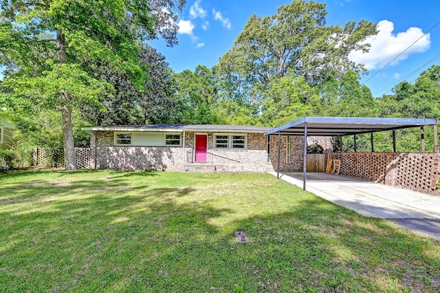 ranch-style home with a front lawn, a detached carport, driveway, and fence