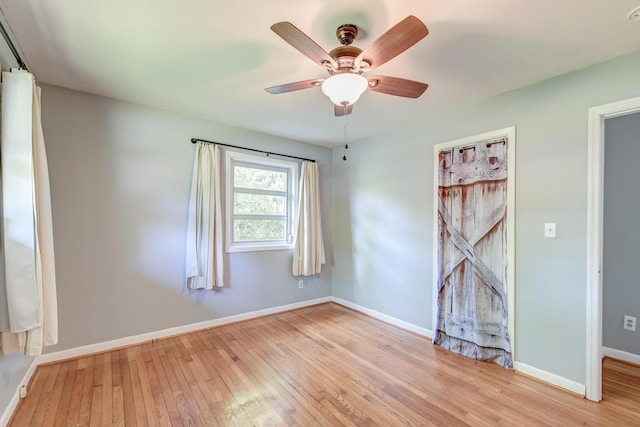 unfurnished room featuring baseboards, ceiling fan, and hardwood / wood-style flooring