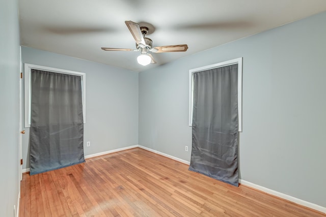 unfurnished room with light wood-style floors, baseboards, and ceiling fan