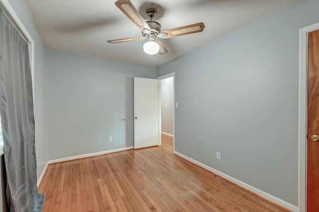unfurnished bedroom with baseboards, a ceiling fan, and hardwood / wood-style floors
