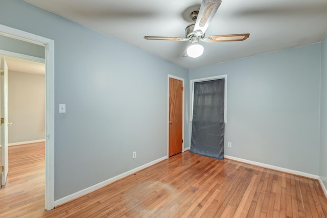 unfurnished bedroom with baseboards, light wood-style flooring, and ceiling fan