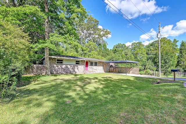 view of front of house with a front yard, fence, stone siding, and an attached carport