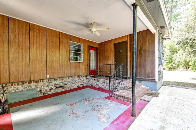 view of exterior entry with ceiling fan