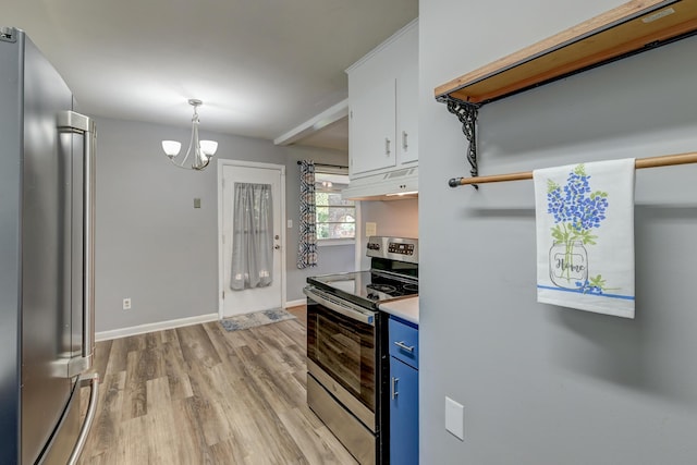 kitchen featuring blue cabinetry, under cabinet range hood, a notable chandelier, light wood-style floors, and stainless steel appliances