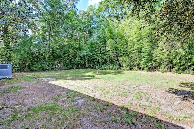view of yard with a view of trees