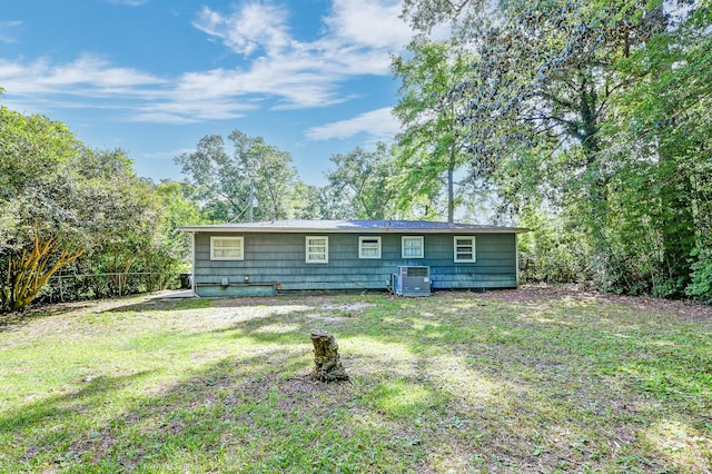 rear view of property with a yard