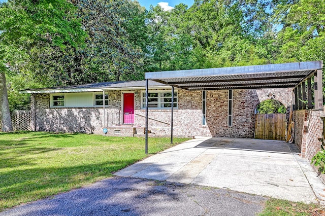 single story home featuring brick siding, driveway, and a front yard