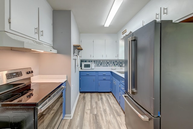 kitchen featuring light wood finished floors, light countertops, blue cabinetry, stainless steel appliances, and under cabinet range hood