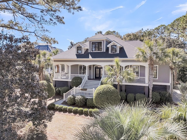 view of front of property featuring stairway and a porch