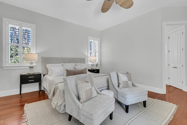 bedroom with wood finished floors, a ceiling fan, and baseboards