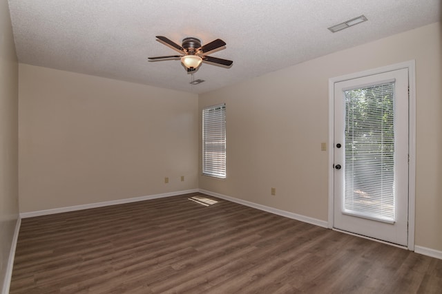 unfurnished room featuring a textured ceiling, dark hardwood / wood-style floors, and ceiling fan