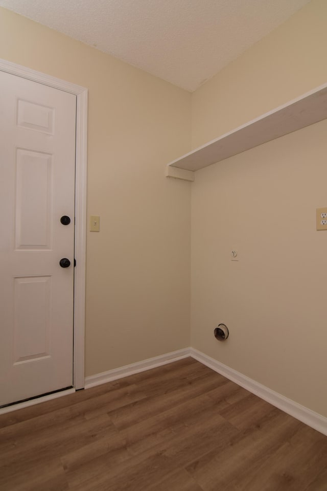 laundry area with hookup for an electric dryer and hardwood / wood-style flooring