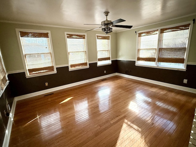 empty room with a wealth of natural light and ornamental molding