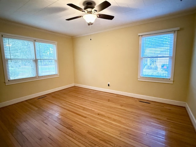 unfurnished room with ceiling fan, light wood-type flooring, and ornamental molding