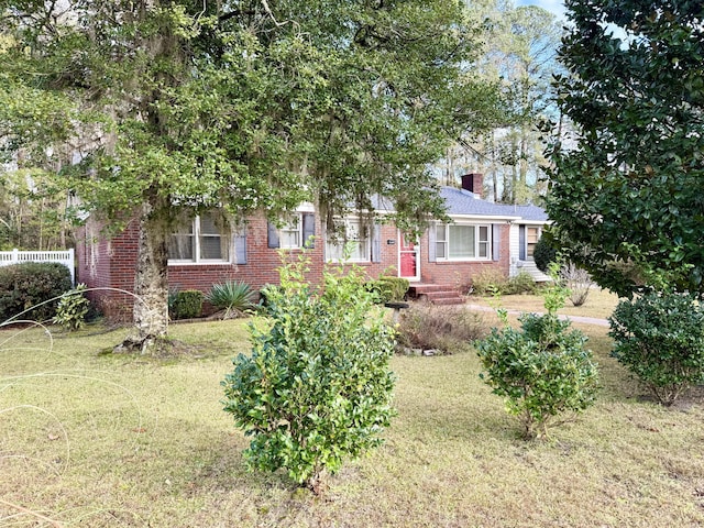 obstructed view of property with a front lawn