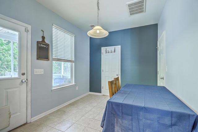bedroom featuring visible vents, baseboards, light tile patterned floors, and multiple windows