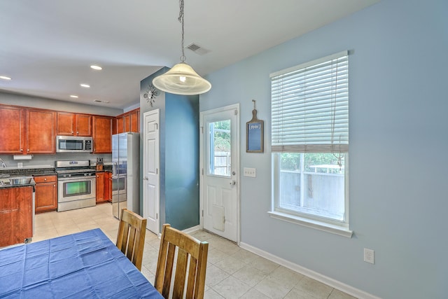 kitchen featuring dark countertops, stainless steel appliances, baseboards, recessed lighting, and visible vents