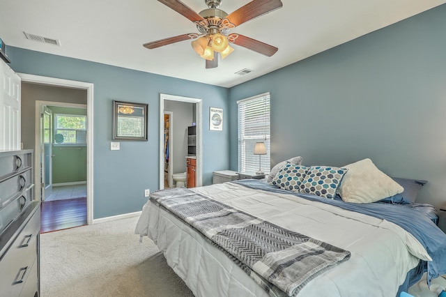 bedroom with carpet floors, a ceiling fan, baseboards, and visible vents