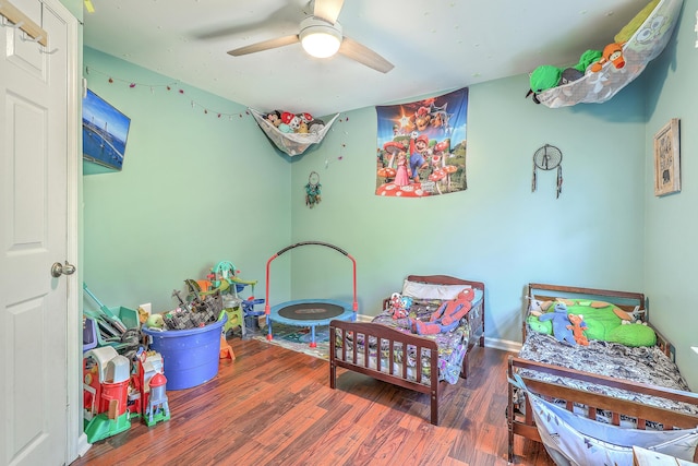 bedroom featuring a ceiling fan and wood finished floors