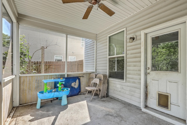sunroom with ceiling fan and a healthy amount of sunlight