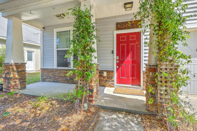 doorway to property featuring covered porch