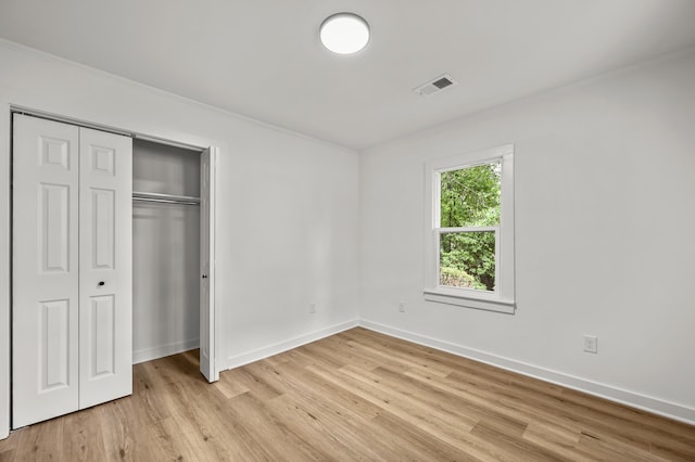 217 Quaker Rd, Saint George, SC 29477 - unfurnished bedroom with baseboards, light wood-style flooring, crown molding, and a closet