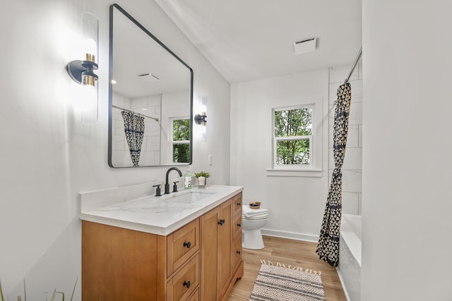 217 Quaker Rd, Saint George, SC 29477 - full bath with vanity, wood finished floors, toilet, shower / tub combo with curtain, and baseboards