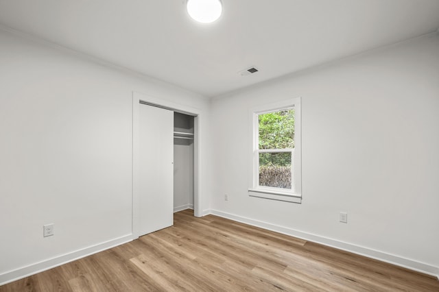 217 Quaker Rd, Saint George, SC 29477 - unfurnished bedroom with light wood finished floors, baseboards, a closet, and ornamental molding