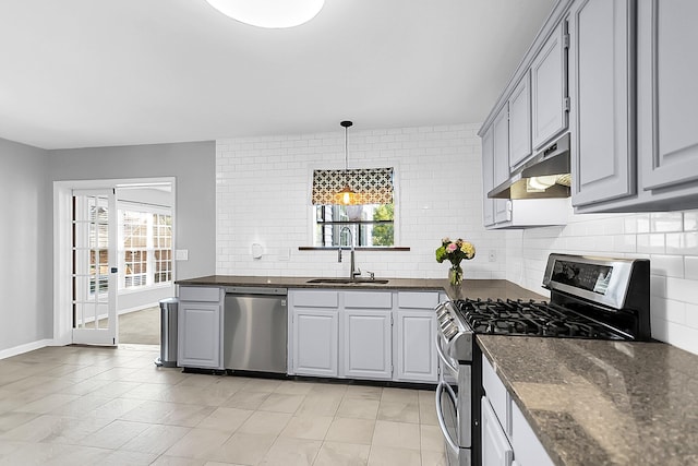 kitchen with decorative backsplash, stainless steel appliances, sink, pendant lighting, and gray cabinets