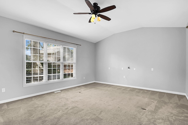 carpeted spare room featuring ceiling fan and lofted ceiling