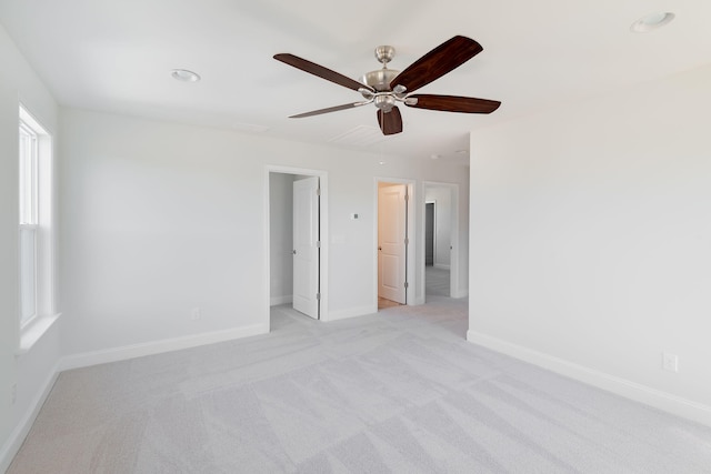 carpeted spare room with ceiling fan