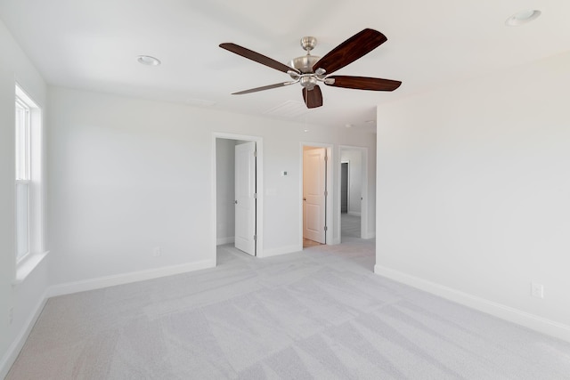 unfurnished bedroom with baseboards, a ceiling fan, and light carpet