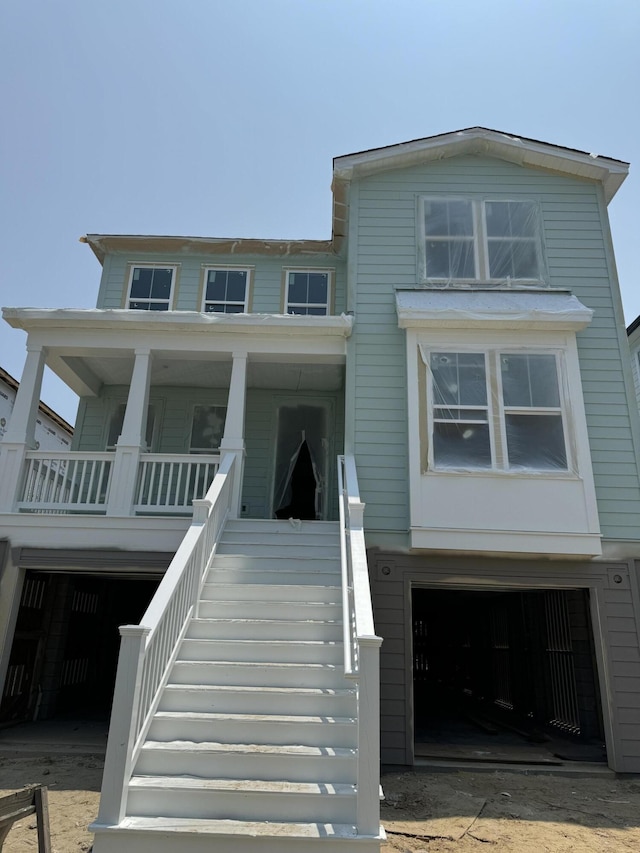 1157 Oak Bluff Ave, Charleston, SC 29492 - view of front of house featuring an attached garage, a porch, and stairway