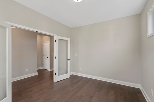 unfurnished room with french doors and dark hardwood / wood-style floors