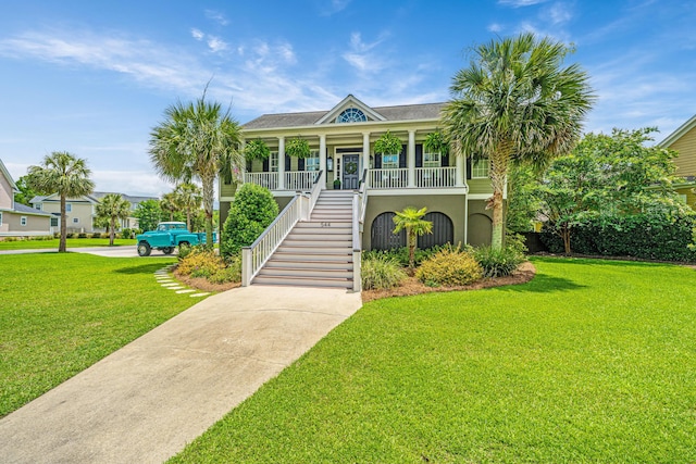 544 Two Mile Run, Johns Island, SC 29455 - beach home with a porch, a front yard, stairs, concrete driveway, and stucco siding