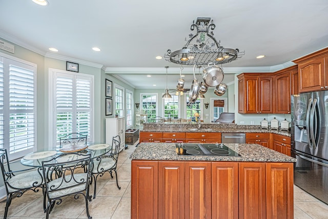 544 Two Mile Run, Johns Island, SC 29455 - kitchen with stainless steel appliances, brown cabinetry, ornamental molding, a center island, and dark stone counters