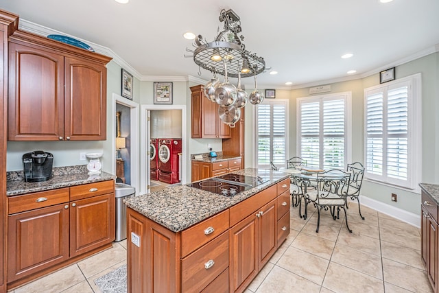 544 Two Mile Run, Johns Island, SC 29455 - kitchen with black electric stovetop, independent washer and dryer, light tile patterned floors, ornamental molding, and stone counters