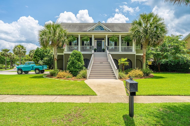 544 Two Mile Run, Johns Island, SC 29455 - raised beach house with stairway, stucco siding, a porch, and a front yard