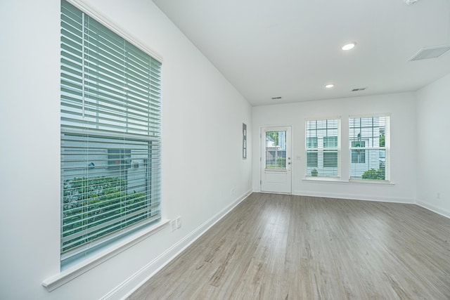 spare room with recessed lighting, visible vents, baseboards, and wood finished floors