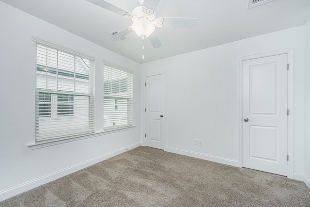 unfurnished room with baseboards, carpet, and ceiling fan