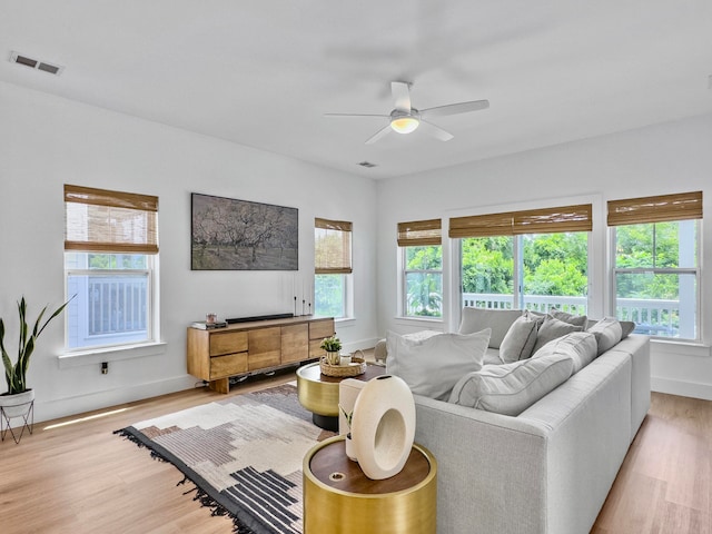 living room featuring ceiling fan and light hardwood / wood-style flooring